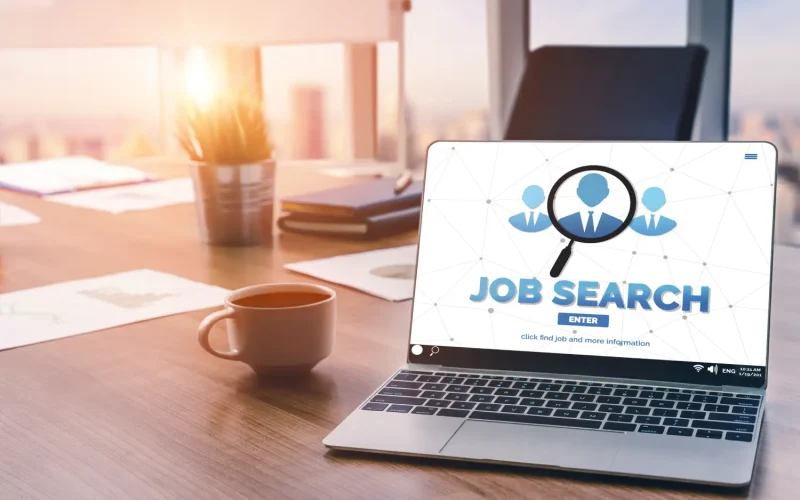 Person browsing job listings on a laptop, exploring various online job boards for job opportunities.