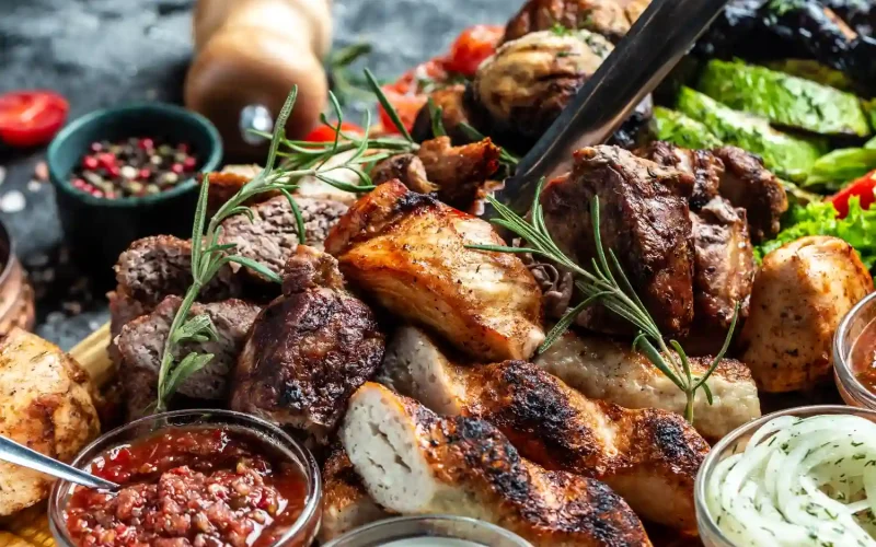 A platter of grilled meats and kebabs served with Persian dips at Iranian restaurants in Charlotte.