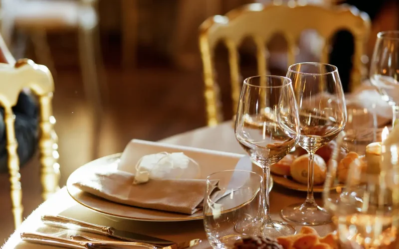 Elegant table setting with glassware and napkins at a fine dining restaurant.