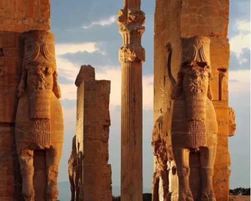 Ancient stone columns and winged bull statues at the Gate of All Nations in Persepolis, Iran.