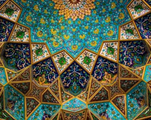 Intricate Persian dome with turquoise tiles and geometric floral patterns, showcasing traditional Persian architecture.
