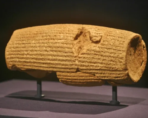 Ancient Persian cuneiform inscription on the Cyrus Cylinder, a clay artifact symbolizing early human rights.