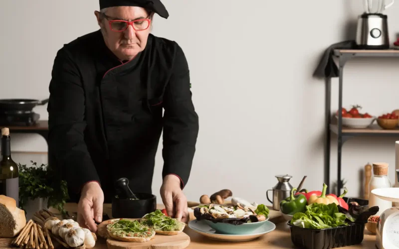 Iranian Restaurants Chef preparing Persian-inspired dishes with fresh ingredients on a wooden counter.