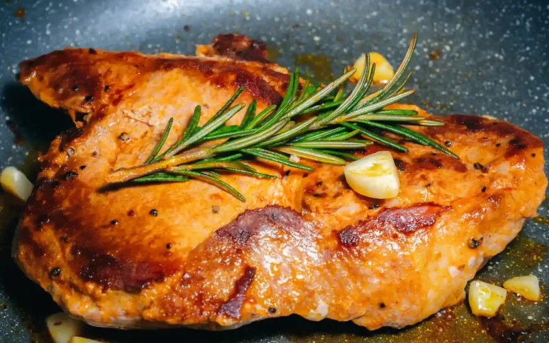 Grilled Persian meat garnished with rosemary and garlic.