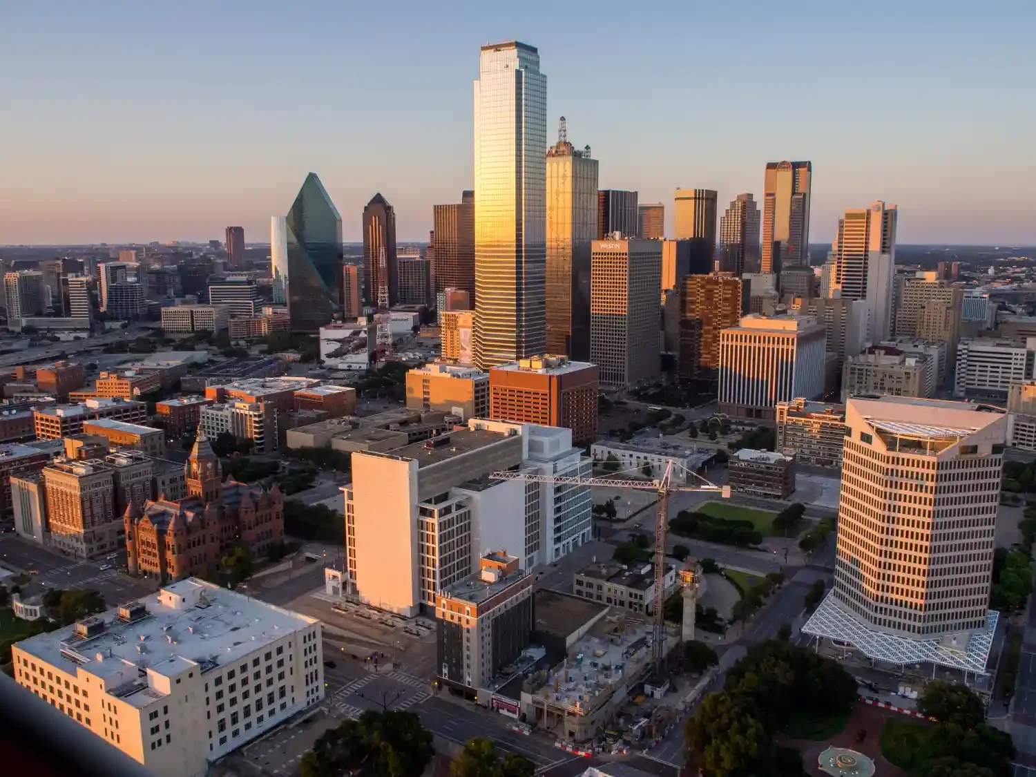 Downtown Dallas skyline at sunset, highlighting the vibrant Iranian Business Community in Dallas.